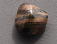 this is a photo of tumbled mugglestone (tiger iron) from South Africa, for a medicine bag, for crystal healing, gemstone massage, gem waters, various metaphysical uses