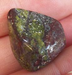 This is a photo of tumbled african bloodstone from western australia, not africa and metaphysically is used to detoxify organs and purify one's blood