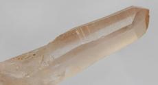 Photo of tangerine pink Lemurian Quartz crystal, very powerful, planted seed by ancient Lemurian civilization