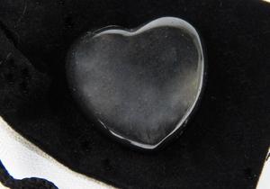 photo of shiny hematite puffy heart, pocket stone, with velour bag and info card, metaphysical crystal