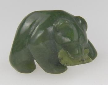 photo of nephrite jade bear carving with fish in its mouth