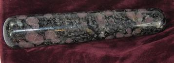 Photo of Large wand made of dark pink spinel crystals in matrix, metaphysical healing stone