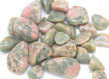Photo of pink and green thulite tumbled stones from washington state, usa. 