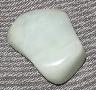 This is a photo of an aquamarine tumbled stone used for chakra balancing, crystal healing, and other metaphysical uses